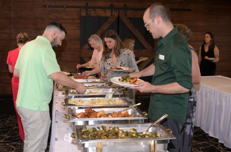 Sampling the food available at the Annual Benefit Dinner